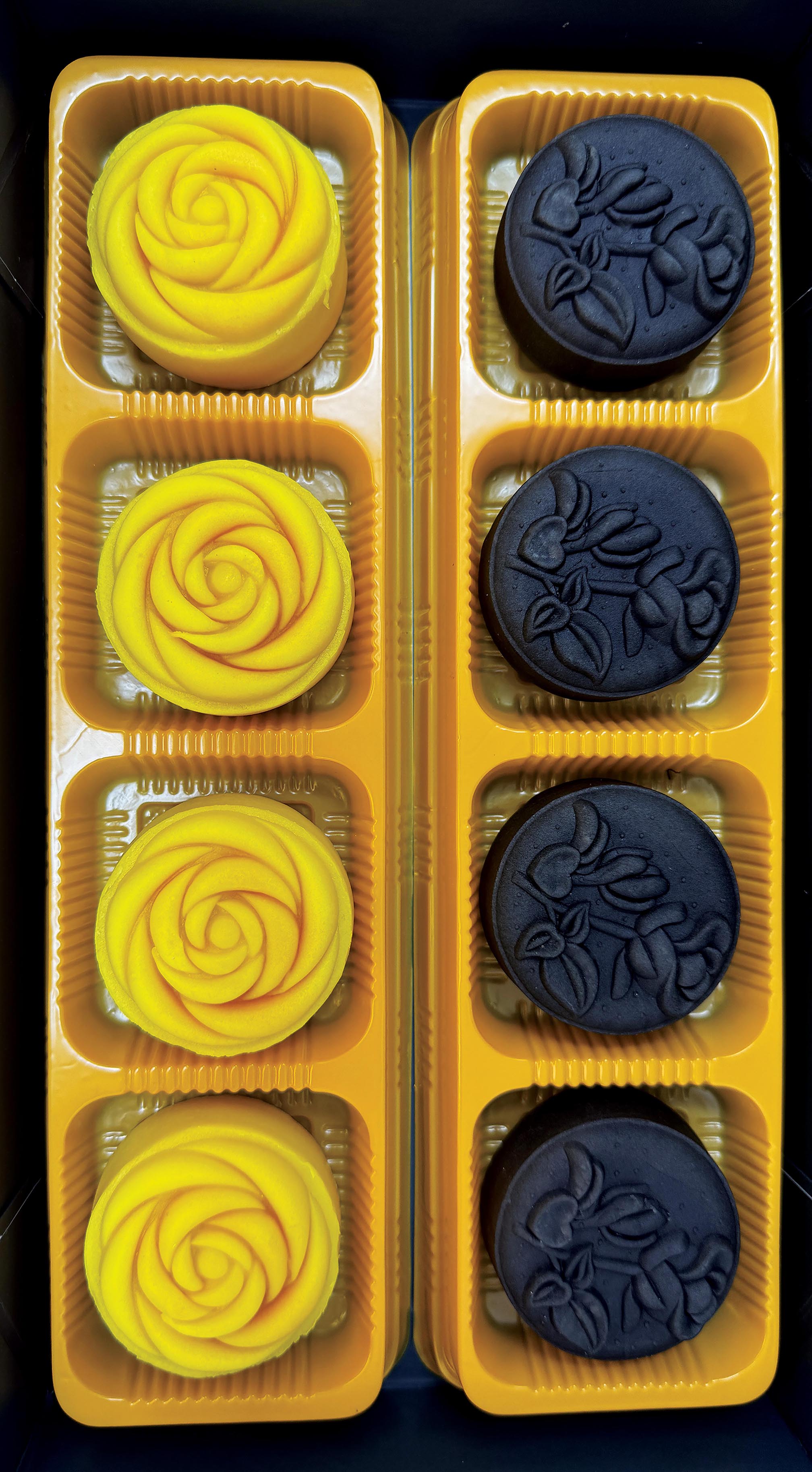 Black Truffle and Custard Lava Mooncake in yellow plastic trays
