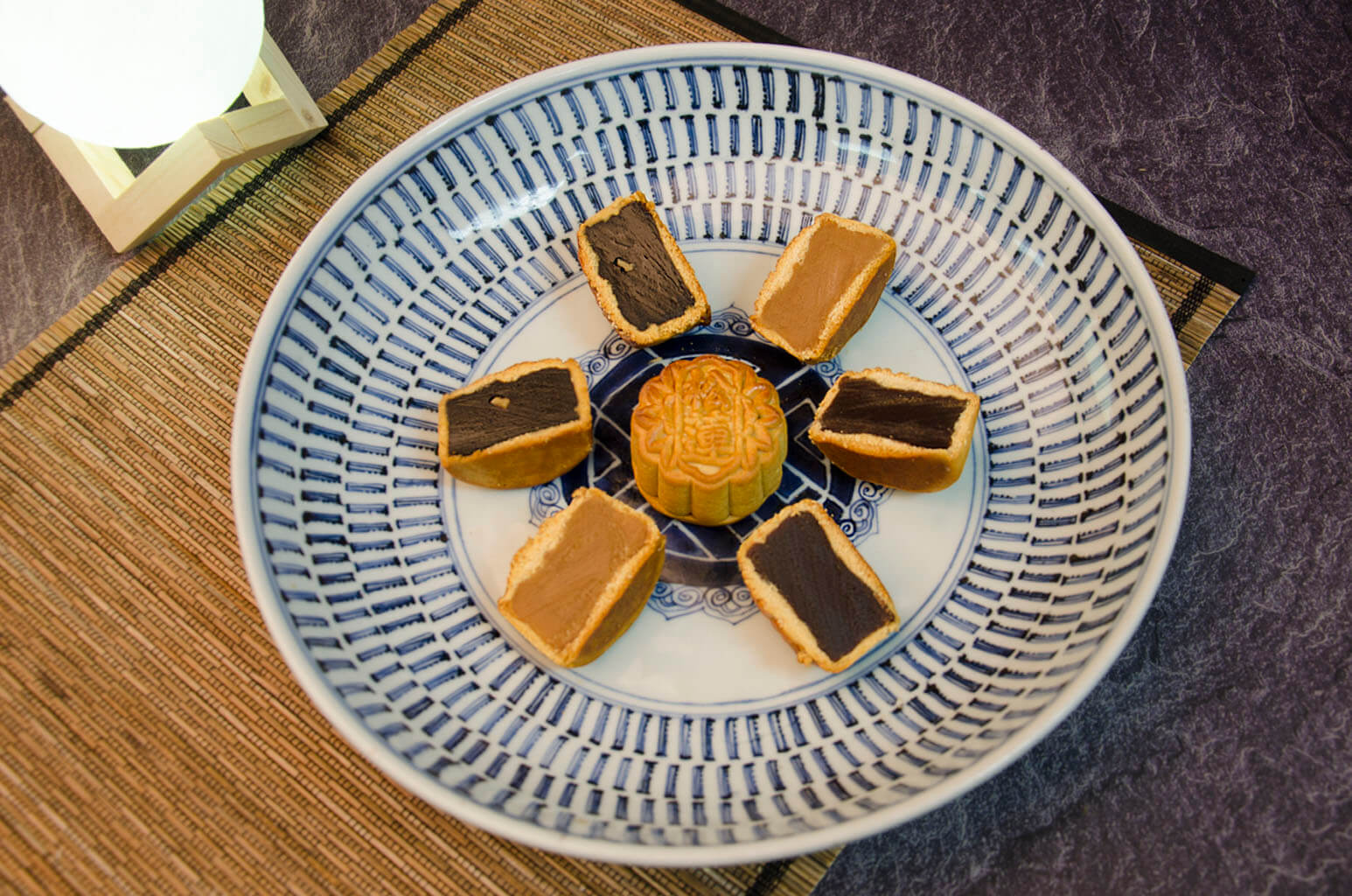 Walnut & Date, Lotus & Yolk, Red Bean, Pineapple, Date, Lotus Mooncakes cut to see filling.