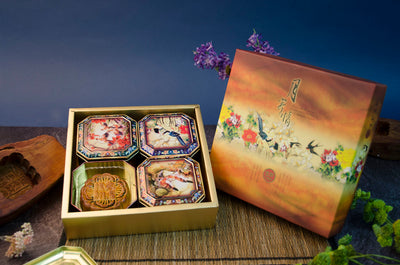 A box of 4 Large Mooncakes, each in a unique patterned metal tin.