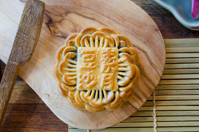 Large Red Bean Mooncake on wooden plate