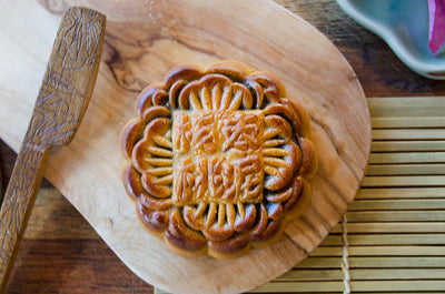 Large Walnut & Date Mooncake on wooden plate